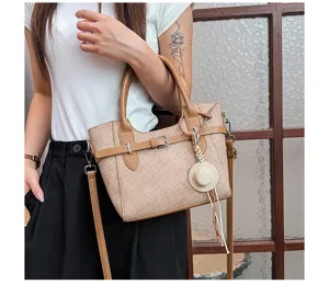 Detailed view of women retro crossbody shoulder bag with chic straw hat charm and color block design.
