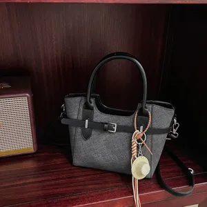 Retro texture women's crossbody handbag with stylish color block design and cute charm.