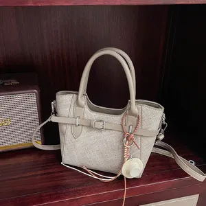 Stylish retro women's handbag, chic PU leather shoulder crossbody tote bag with cute hat pendant.