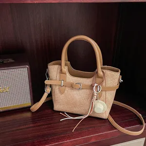 Retro brown shoulder crossbody tote bag with chic belt buckle and cute mini hat pendant.
