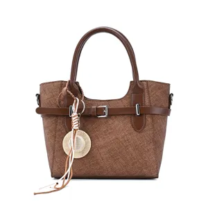 Vintage brown women handbag with double handles, stylish belt buckle and cute straw hat charm.