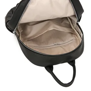 Inside view of a black women casual backpack showing spacious herringbone lining and storage pockets.
