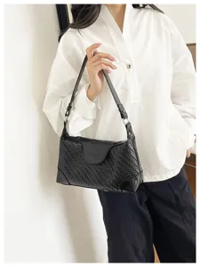 Stylish black woven underarm shoulder bag for women, chic commuter crossbody handbag accessory.