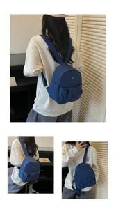 Detail view of the minimalist blue mini backpack worn on back, showing compact casual style.