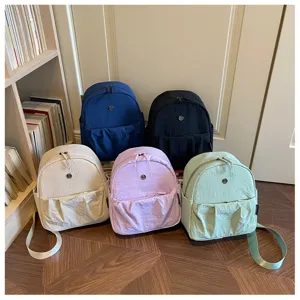 Detailed view of casual minimalist daily backpacks in multiple solid colors, lightweight fabric.