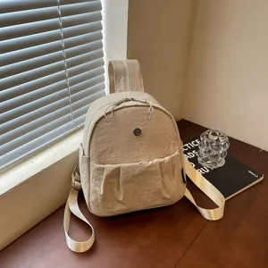 Casual nylon backpack for women, minimalist daily daypack with front pocket and shoulder straps.