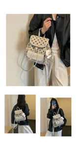 Close-up detail showing the chic polka dot pattern, front pocket, and cute plush keychain.