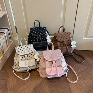 Fashionable polka dot backpack with cute dog pendant, casual daily school bag for women.