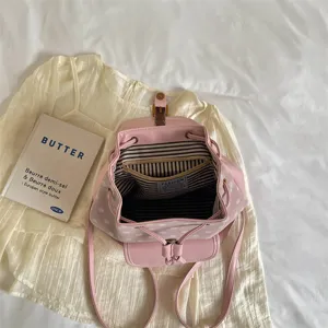 Stylish pink polka dot casual backpack for women, ideal for daily commute and school.
