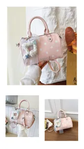 Detailed view of the pink polka dot pillow shoulder bag with lace musical note accessory.