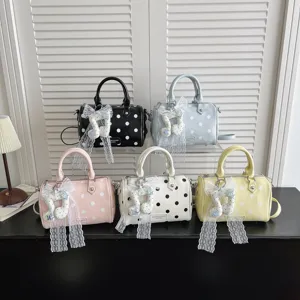 Women stylish polka dot pillow handbag with lace bow and cute music note pendant.
