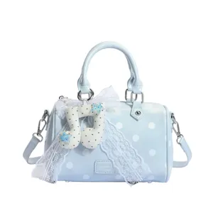 Light blue polka dot barrel bag with sweet lace and musical note pendant, main view.