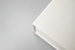 Close-up detail view of the white gift box edge, showing premium textured fabric surface.