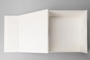 Detailed top view of a large white foldable magnetic gift box open on a clean grey surface.