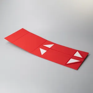 Flat unfolded red gift box detail showing premium folding cardboard packaging structure and creases.