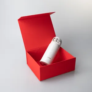 Detailed view of white vacuum insulated travel mug in elegant red presentation gift box.