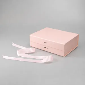 Pink folding gift box detail, premium paper box with matching ribbon for luxury packaging.