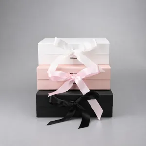 Premium foldable gift boxes with ribbon bows, stackable cardboard boxes for apparel and present.