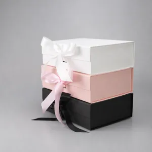 Premium foldable gift boxes set with ribbons in white pink and black for packaging presentation