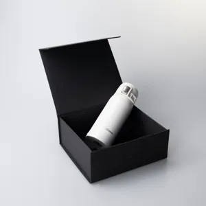 Close-up view of a white vacuum insulated flask displayed inside an elegant black gift box.