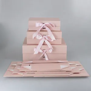 Pink folding gift box with ribbon bow, premium collapsible apparel packaging box for present.