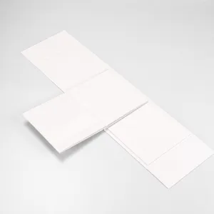Detail view of a white one-piece folding gift box, square hard cardboard box design.