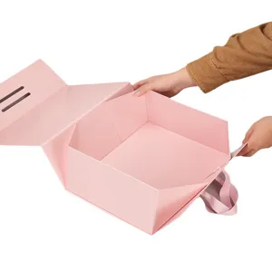 Large pink foldable gift box with ribbon handle, elegant flip lid packaging for shoes and gifts.