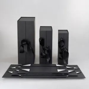 Detail view of custom black folding gift boxes with ribbon, ideal for apparel and luxury items.