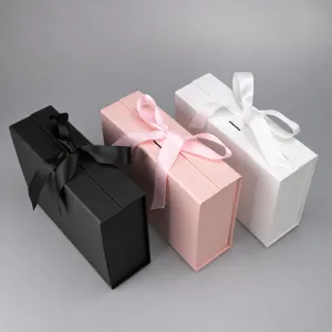 Luxury folding gift boxes with ribbon closures in black, pink, and white for apparel packing.