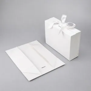 White folding gift box with ribbon, elegant apparel packaging box for luxury gifts.