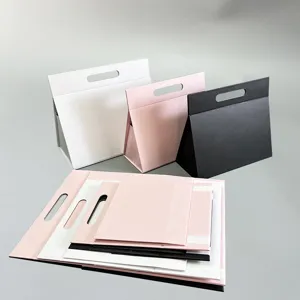 Faltbare magnetische Geschenkschachtel in Weiß, Rosa und Schwarz, dreieckiges Design.