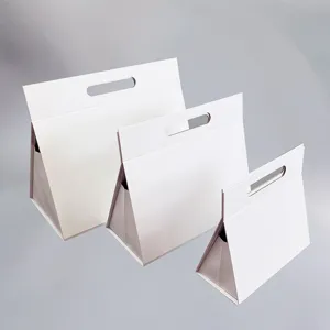 Détail de boîte cadeau triangulaire blanche, conteneur pliable en carton avec poignée emballage.