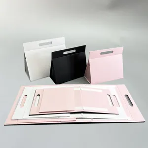 Detailansicht der faltbaren Dreieck-Geschenkbox in Schwarz, Weiß und Rosa mit Magnetverschluss.