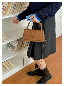 Stylish brown woven shoulder bag with chic twist lock and handle for daily commute chic look.
