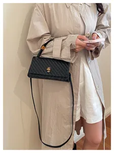Black woven shoulder crossbody bag for women, stylish commuting handbag with clasp.