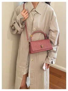 Chic pink woven shoulder bag for women, stylish crossbody handbag with top handle and lock.