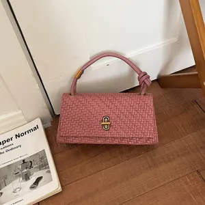Pink woven leather shoulder bag with chic metal lock, stylish casual handbag for women.