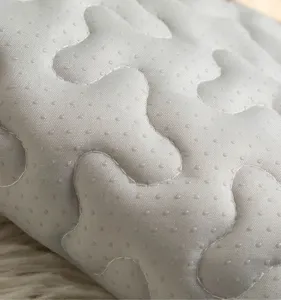 Grey pet mat detail shot showing bone quilted pattern and anti-slip dots, comfortable for dogs.