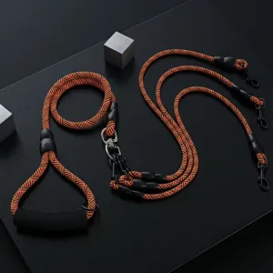 Multi-dog leash detail shot, orange and black woven rope with comfortable handle.