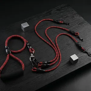 Multi-dog leash detail shot showing durable red-black braided rope and heavy-duty metal clasps.