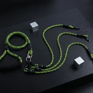 Detail view of the durable braided multi-dog leash in neon green and black with metal clasps.