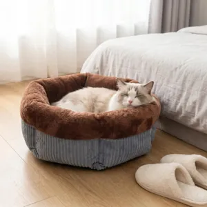 Cozy round plush pet bed with soft brown interior and grey corduroy exterior for cats and dogs.