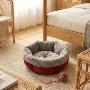 Cozy round plush pet bed with soft grey interior and red corduroy exterior for cats and dogs.