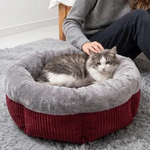 Cozy round pet bed with plush rim and corduroy exterior, ideal for cats and small dogs.