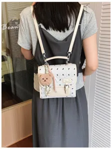 Collegiate style bow print mini backpack with cute bear pendant, trendy casual double strap.