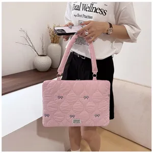 Pink quilted laptop bag with cute blue bow embroidery, stylish shoulder and tote bag design.