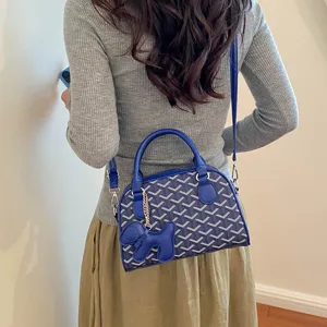 Stylish blue chevron pattern women crossbody handbag with top handle and cute dog pendant accessory.