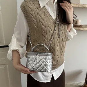 Detailed view of the stylish silver quilted crossbody bag with metal chain and top handle.