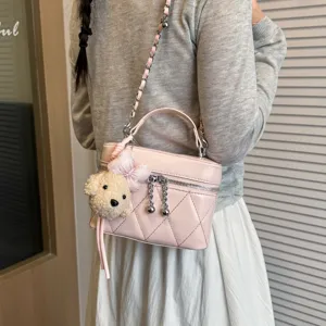 Pink quilted vanity cross body bag with chain strap and cute puppy plush charm accessory.