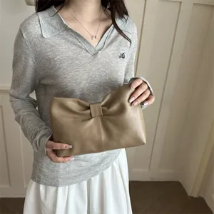 Khaki leather bow clutch bag for women, elegant minimalist underarm purse for daily commute.